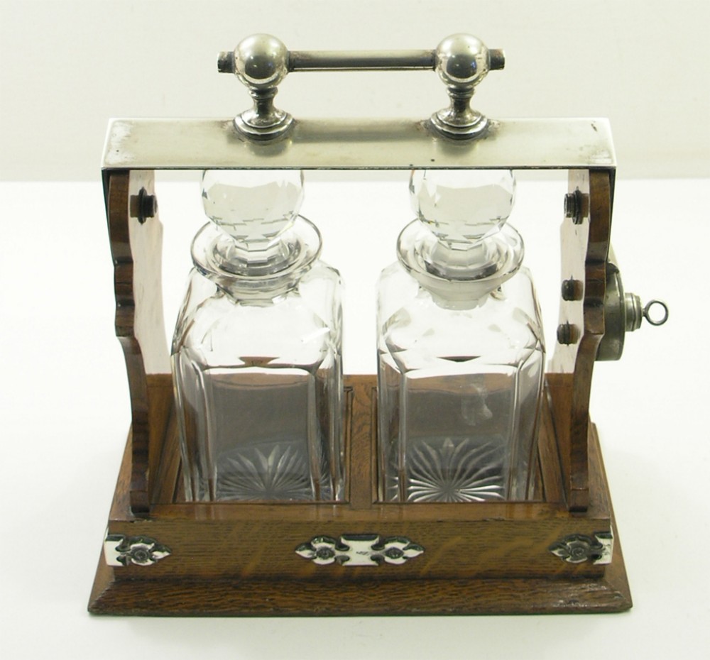 GOOD EDWARDIAN OAK TWO DECANTER TANTALUS. COMPLETE.