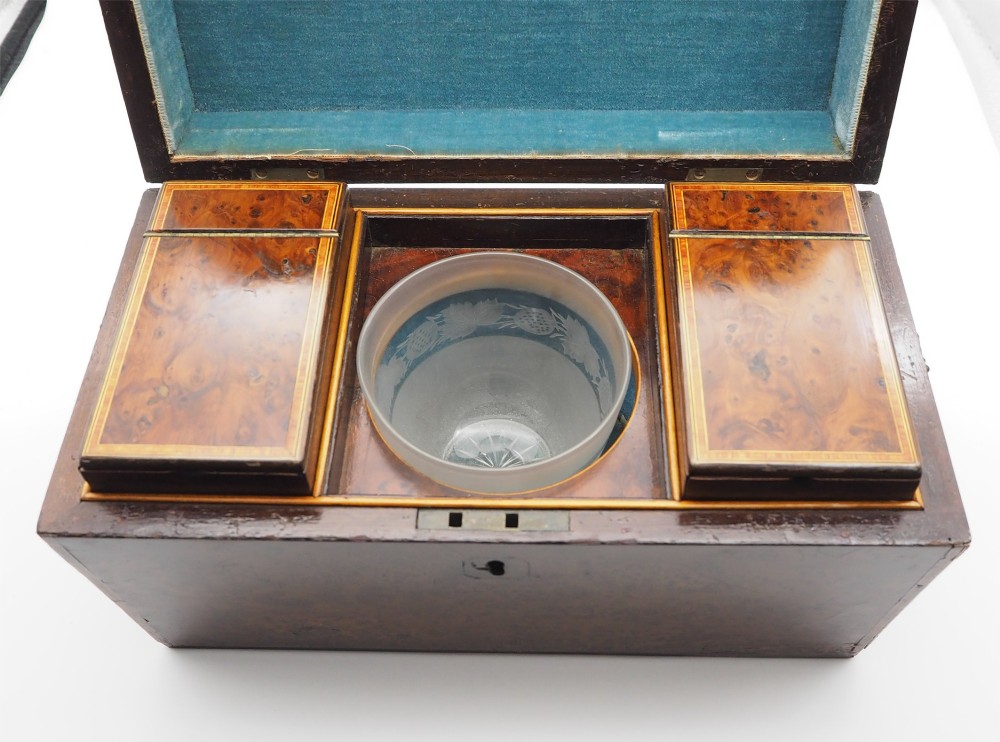 A Regency period sarcophagus-shaped tea caddy crafted from figured burr yew wood with fine string inlay. View VII