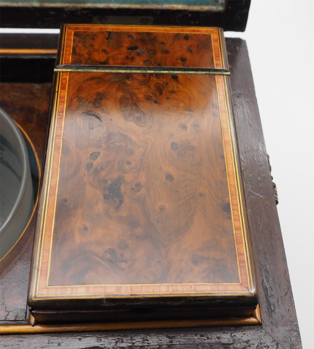 A Regency period sarcophagus-shaped tea caddy crafted from figured burr yew wood with fine string inlay. View VIII