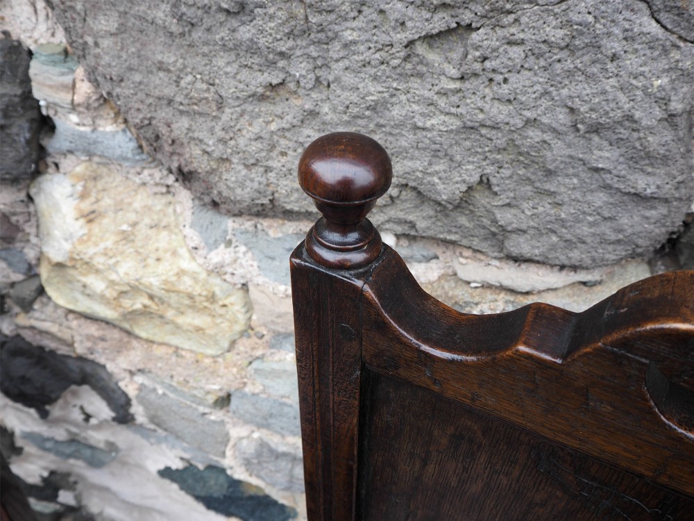A pair of dark carved oak 17th-century hall chairs featuring geometric diamond back panels and turned legs. View VIII