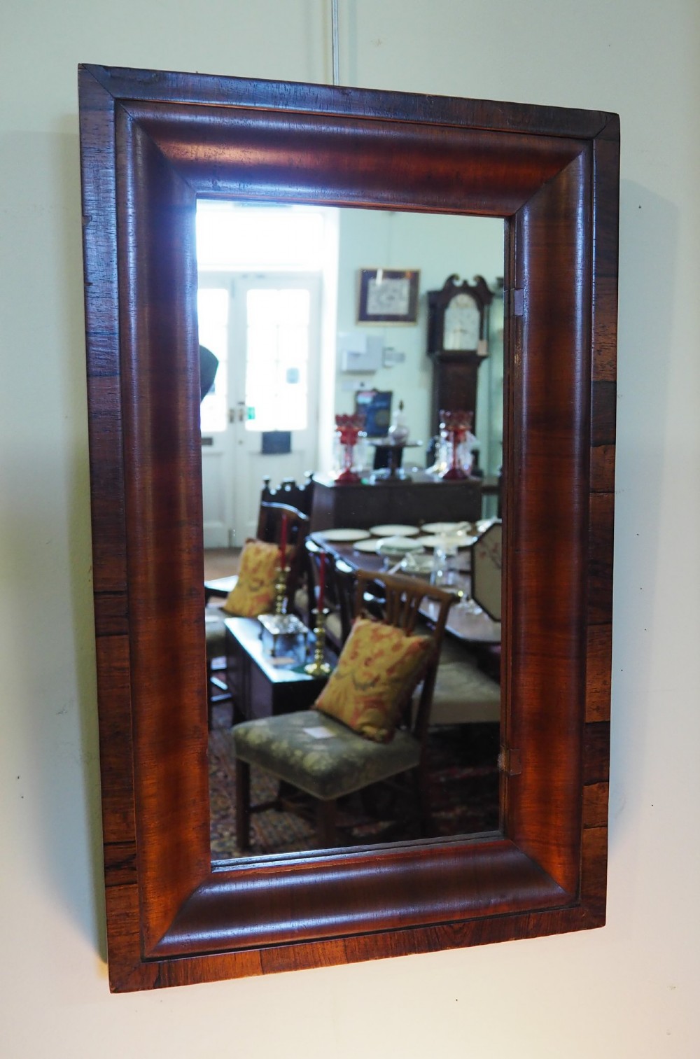 A 19th-century rectangular wall mirror featuring a deep cushion moulding frame crafted from dark rosewood veneer with mitred corners. View II