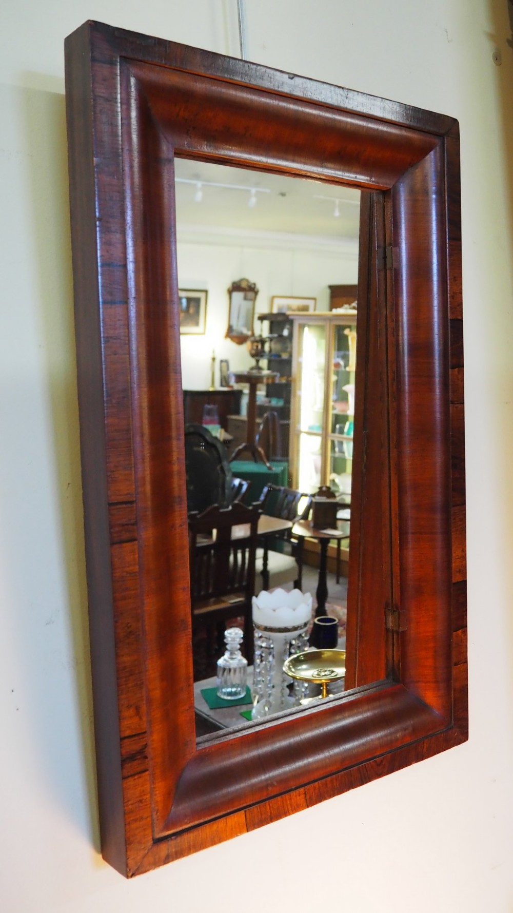 A 19th-century rectangular wall mirror featuring a deep cushion moulding frame crafted from dark rosewood veneer with mitred corners. View III