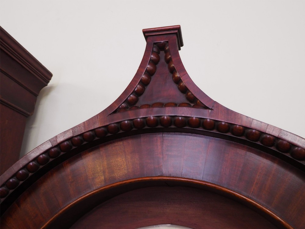 A tall Scottish mahogany longcase clock featuring a painted arch dial depicting an equestrian figure, flame mahogany cabinet trunk, and reeded side columns. View VII
