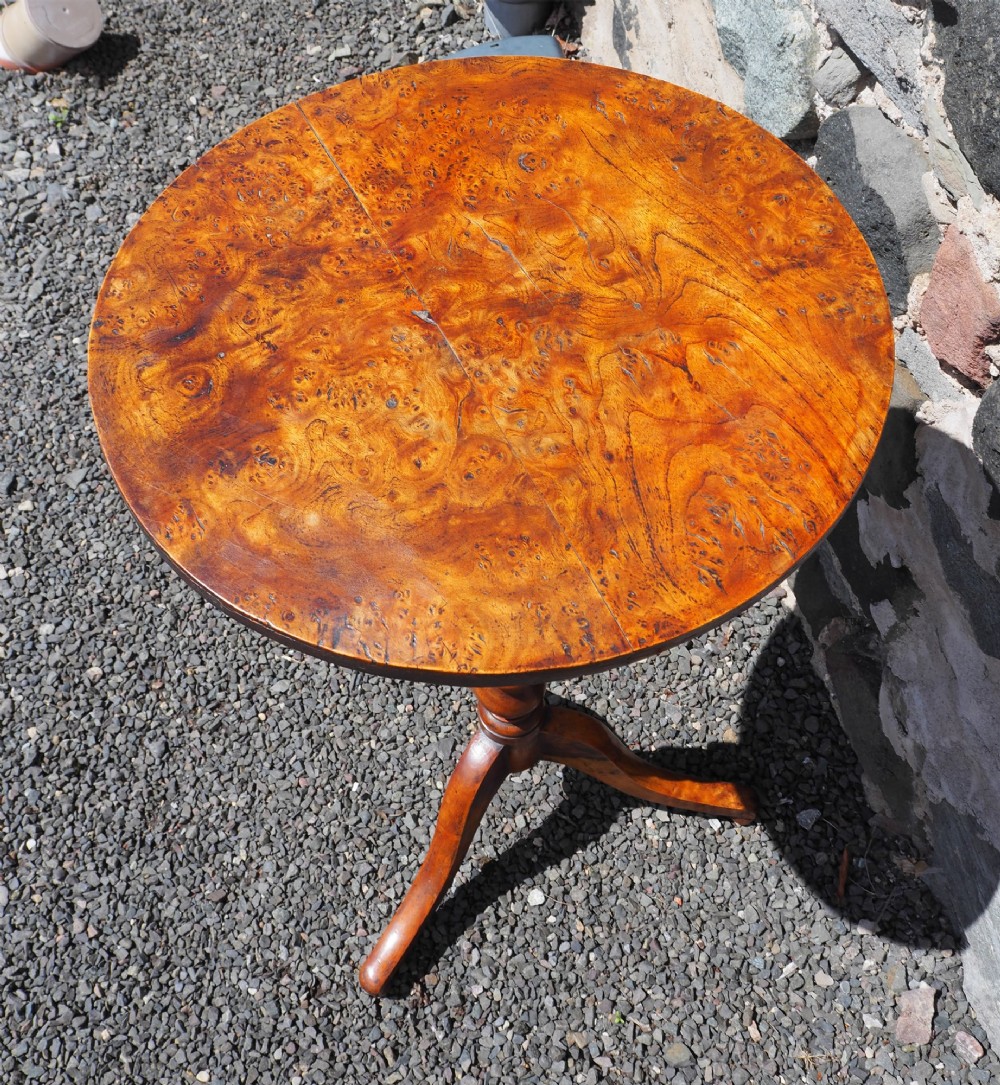 A Georgian burr elm tripod table featuring a circular top, turned pedestal column, and three splayed legs. View III