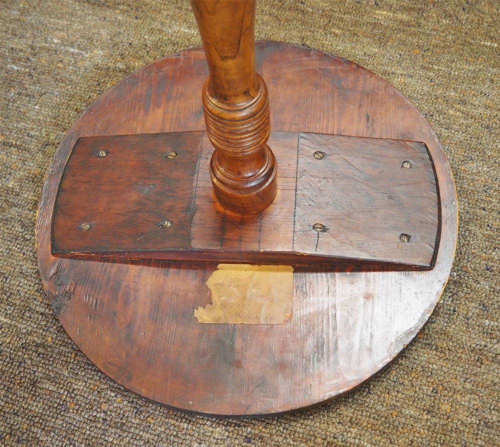 A Georgian burr elm tripod table featuring a circular top, turned pedestal column, and three splayed legs. View V