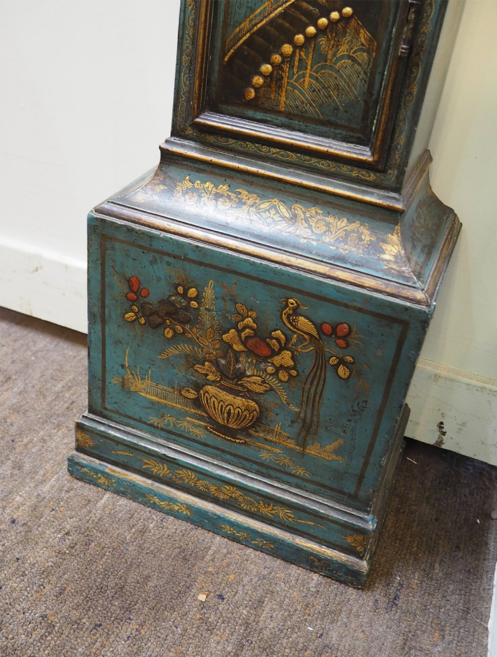 A blue lacquered grandmother clock decorated with gilt chinoiserie figural scenes and an arched brass dial. View V