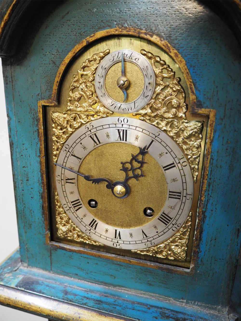 A blue lacquered grandmother clock decorated with gilt chinoiserie figural scenes and an arched brass dial. View IX