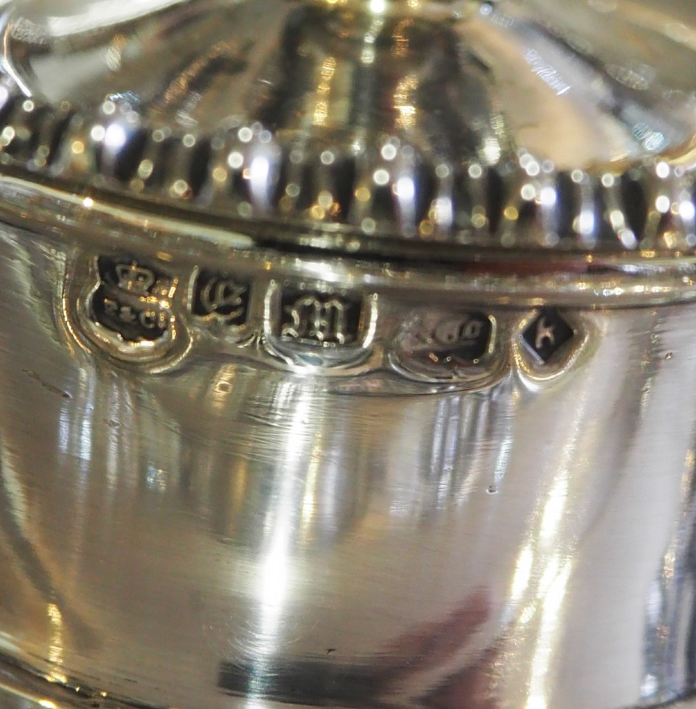 An antique silver-plated rectangular desk tray featuring a pierced gallery edge, two cut glass inkwells, a central taper holder, and a recessed pen groove. View IX