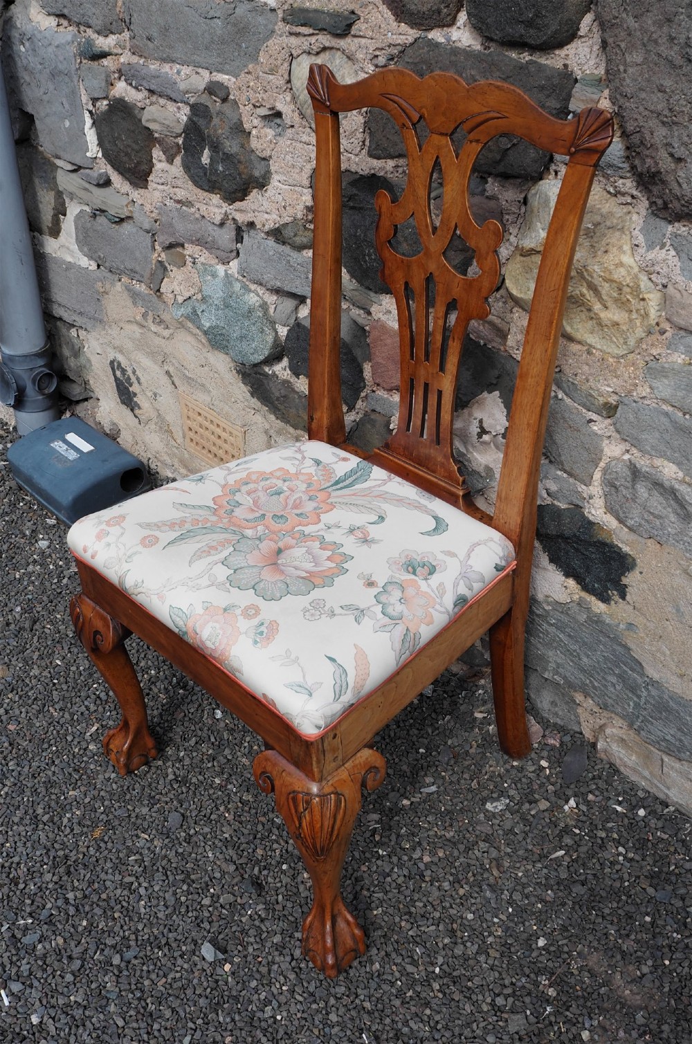 An antique George II walnut side chair with a pierced splat back, floral upholstered seat, and cabriole front legs ending in carved ball and claw feet. View II
