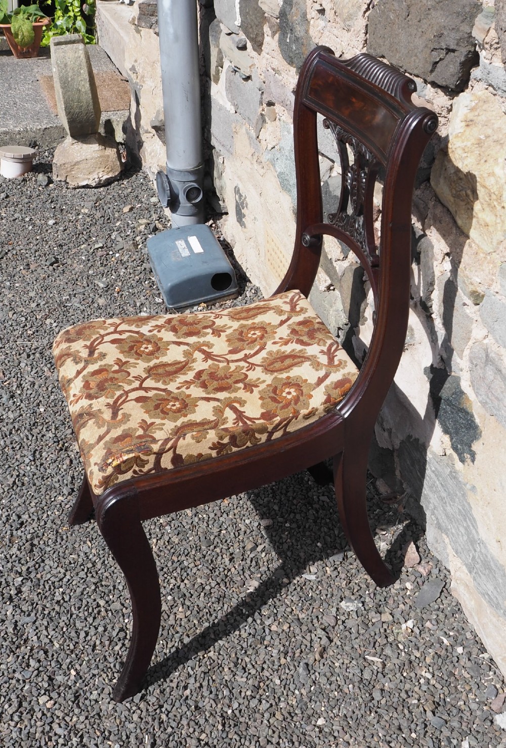 A Regency Cuban mahogany side chair featuring a carved crest rail, an anthemion splat, and a floral upholstered seat. View II