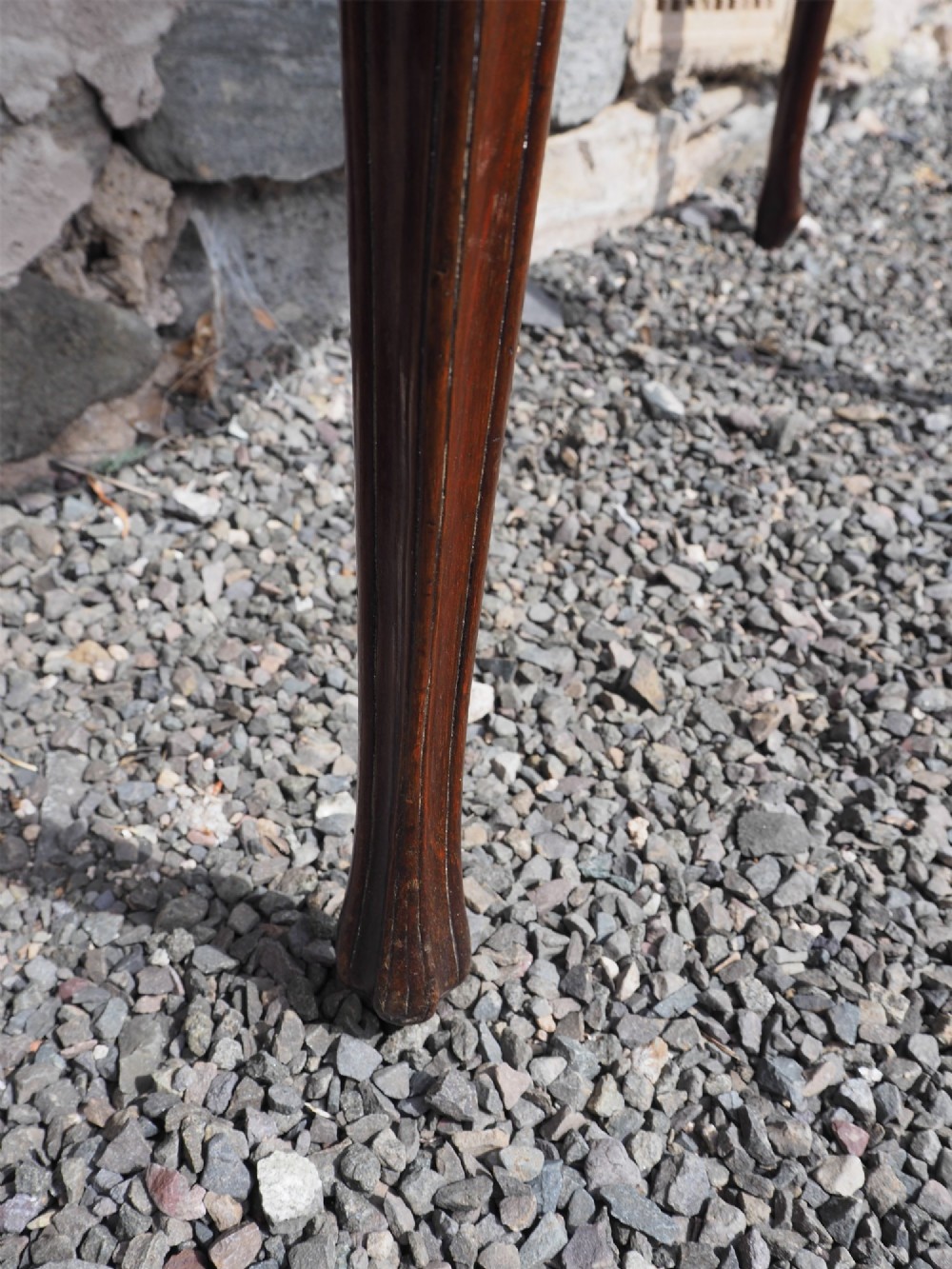 An 18th-century demilune folding card table crafted with flame mahogany veneer and carved slender legs. View VI