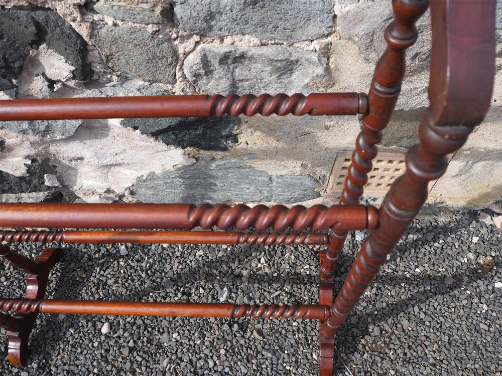 A freestanding Edwardian mahogany towel rail featuring barley twist turned uprights, horizontal crossbars, and curved trestle feet. View IV