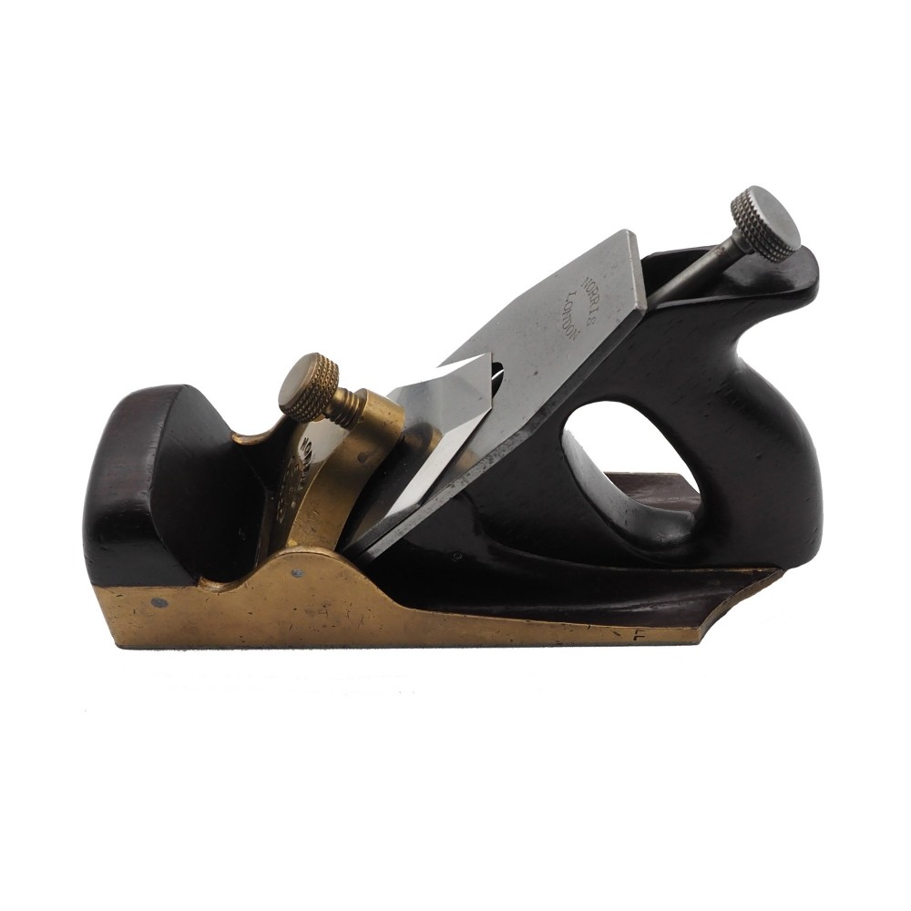 An antique Norris London 51G smoothing plane featuring a gunmetal frame, dark hardwood infill, and adjustable steel cutter. View II