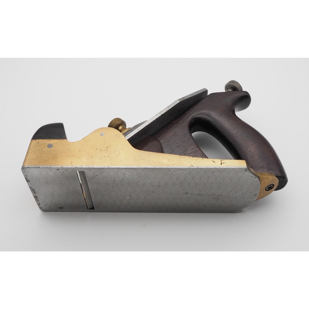 An antique Norris London 51G smoothing plane featuring a gunmetal frame, dark hardwood infill, and adjustable steel cutter. View IV