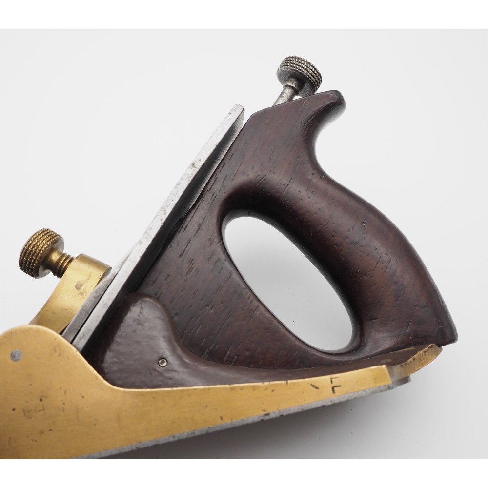 An antique Norris London 51G smoothing plane featuring a gunmetal frame, dark hardwood infill, and adjustable steel cutter. View V