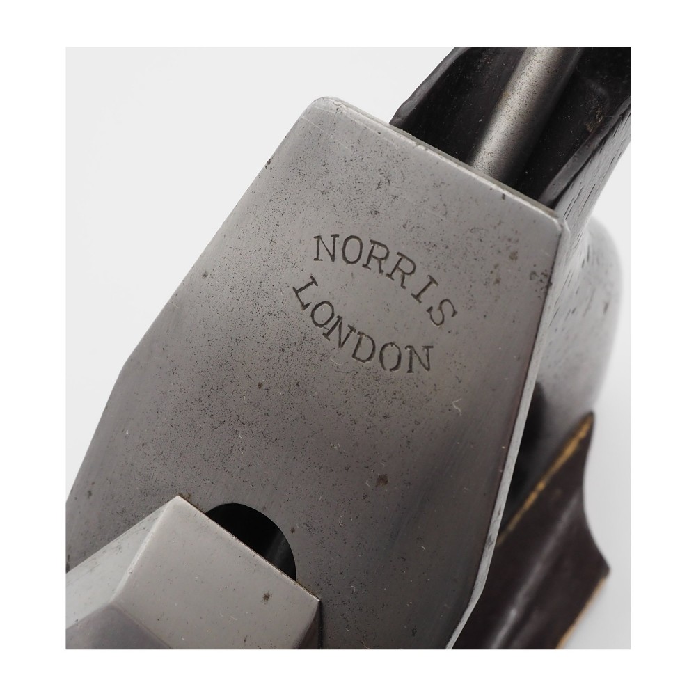 An antique Norris London 51G smoothing plane featuring a gunmetal frame, dark hardwood infill, and adjustable steel cutter. View VIII