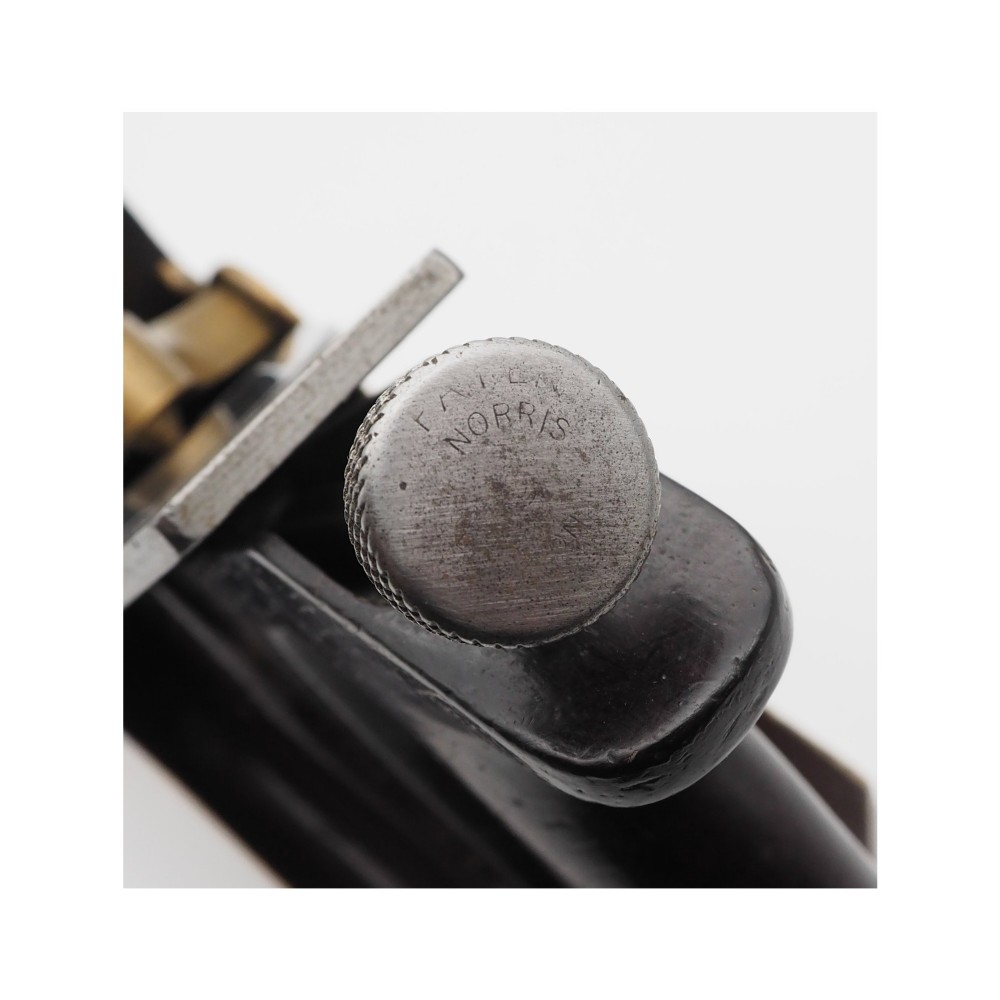 An antique Norris London 51G smoothing plane featuring a gunmetal frame, dark hardwood infill, and adjustable steel cutter. View IX
