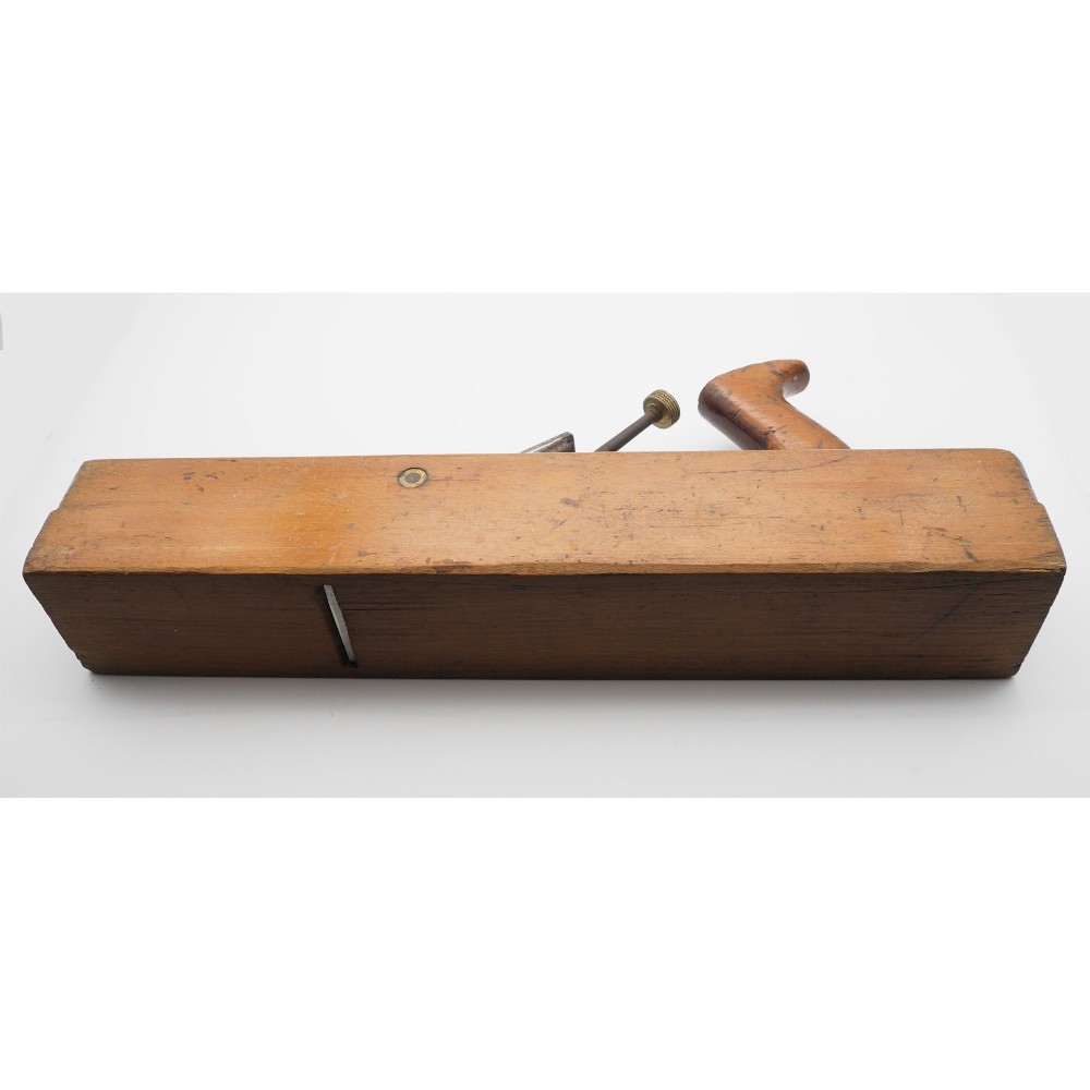 An antique wooden panel plane featuring a beech body, shaped rear handle, steel cutting iron, and brass adjustment mechanism. View III