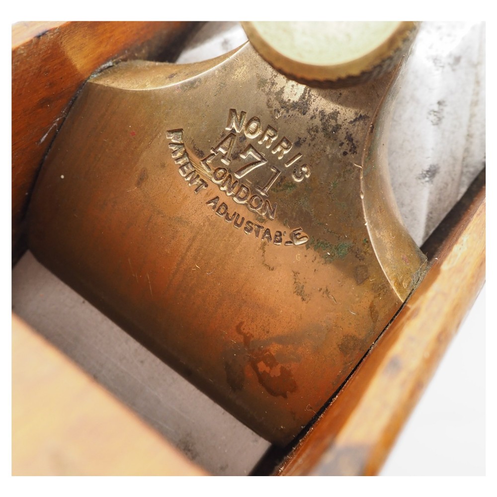 An antique wooden panel plane featuring a beech body, shaped rear handle, steel cutting iron, and brass adjustment mechanism. View V