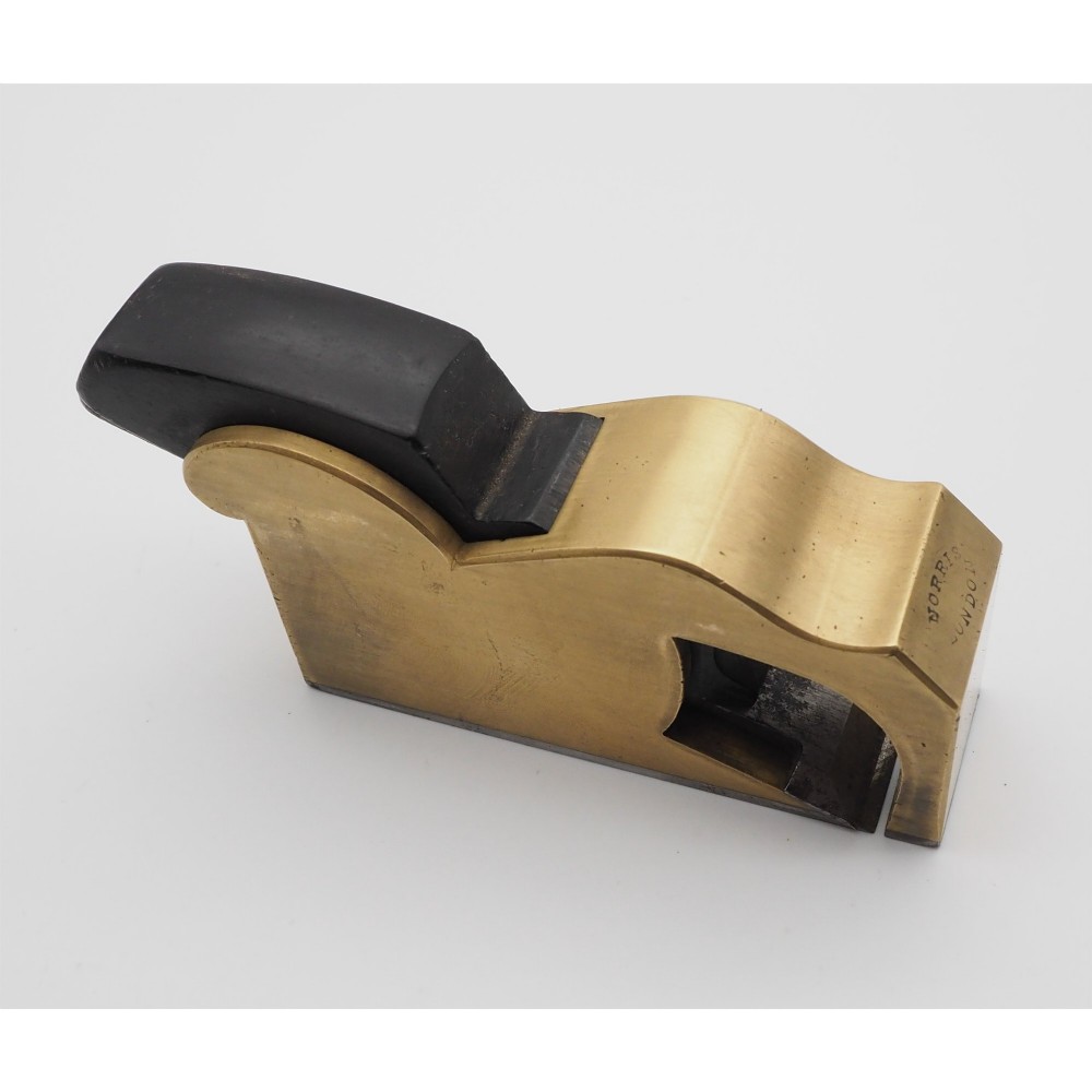 A Norris London No. 27 gunmetal bullnose woodworking plane featuring a polished brass body, stamped maker mark, and dark wooden wedge. View II