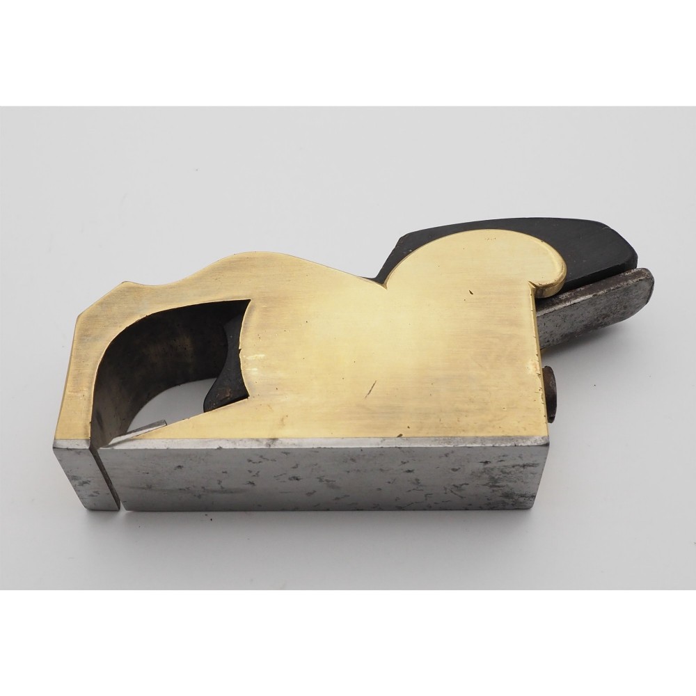 A Norris London No. 27 gunmetal bullnose woodworking plane featuring a polished brass body, stamped maker mark, and dark wooden wedge. View IV