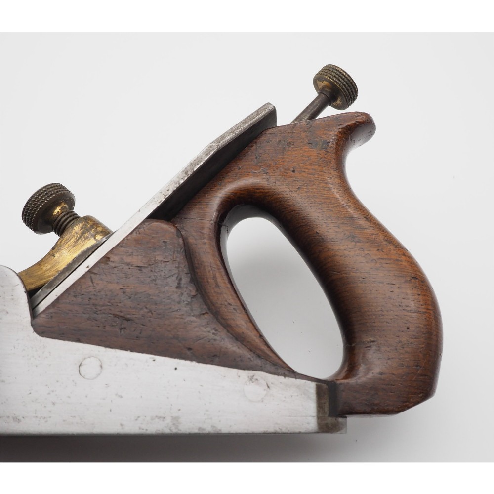 A Norris London A5 patent adjustable smoothing plane with a cast steel body, dark hardwood infill, and brass lever cap. View V