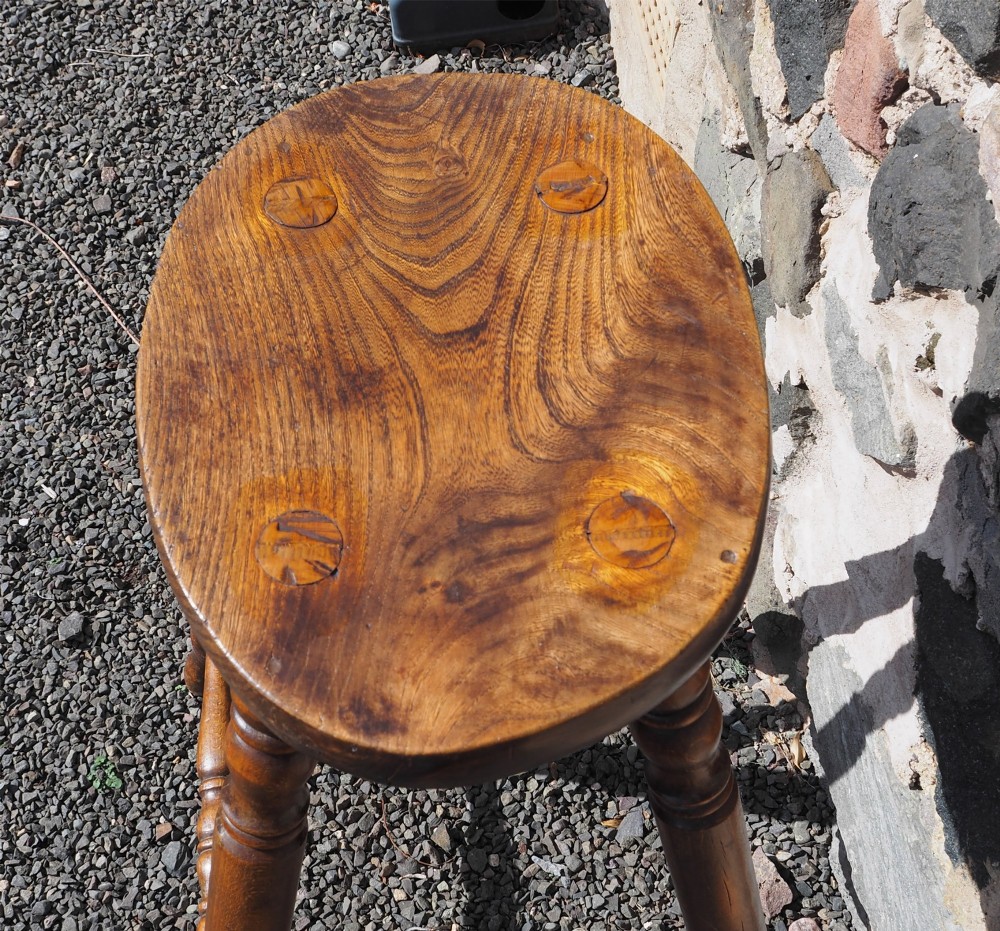 A 19th-century high stool constructed from ash and beech timber, featuring turned splayed legs, foot stretchers, and a rounded wooden seat. View IV