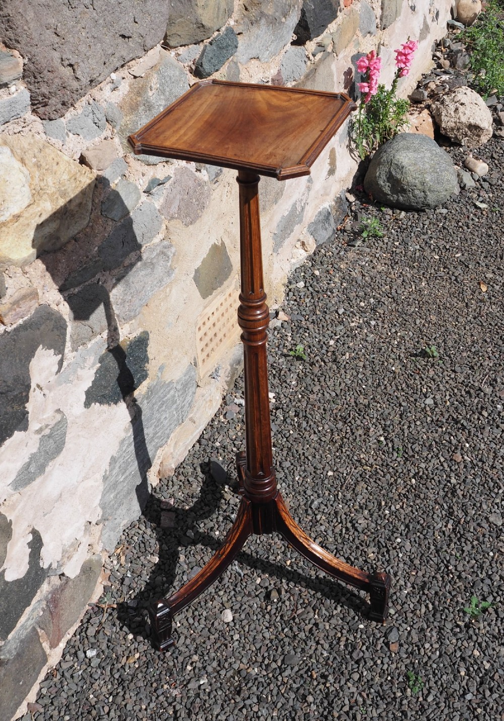 An 18th-century Dutch walnut torchere featuring a turned tapered column, shaped square tray top, and carved tripod legs. View III
