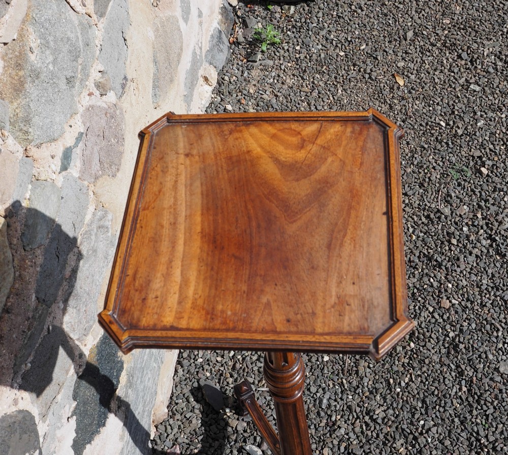 An 18th-century Dutch walnut torchere featuring a turned tapered column, shaped square tray top, and carved tripod legs. View IV