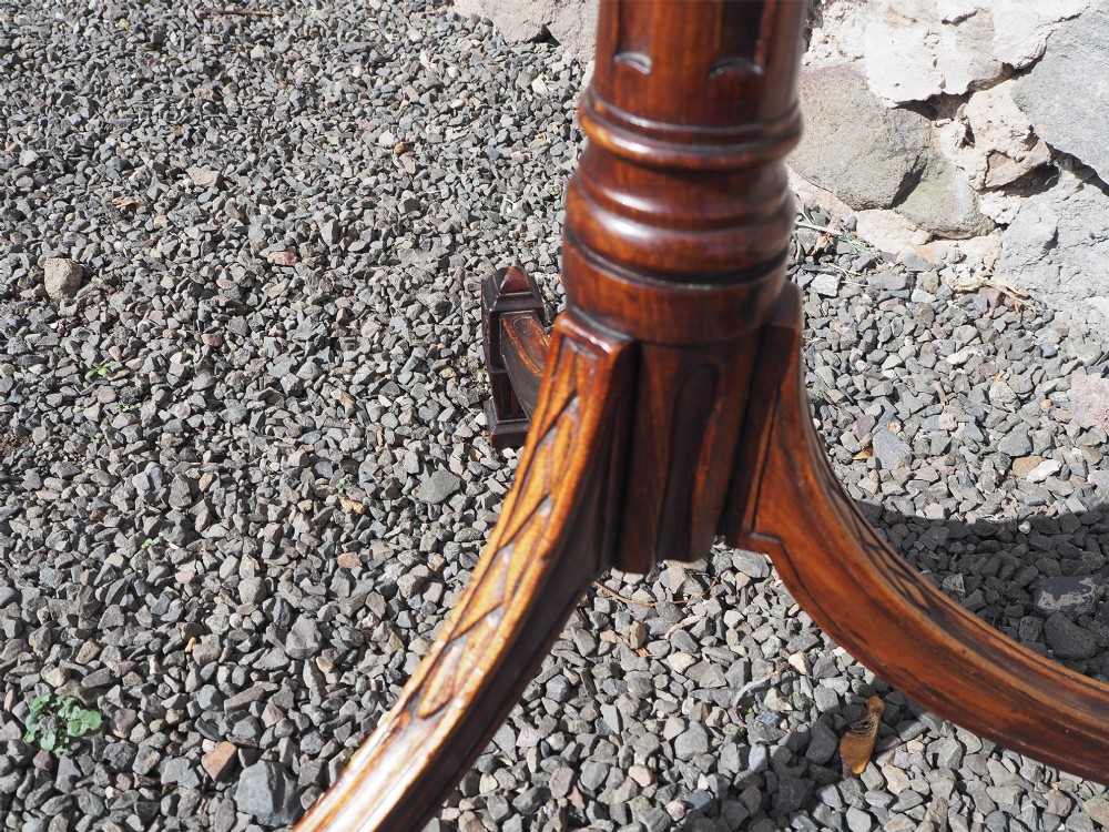 An 18th-century Dutch walnut torchere featuring a turned tapered column, shaped square tray top, and carved tripod legs. View VI