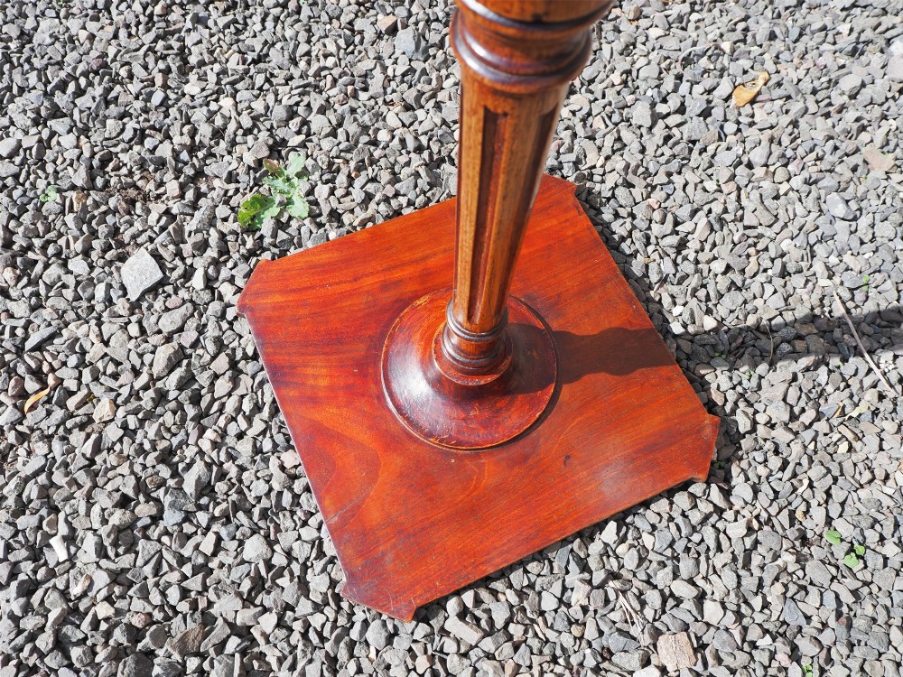 An 18th-century Dutch walnut torchere featuring a turned tapered column, shaped square tray top, and carved tripod legs. View VII
