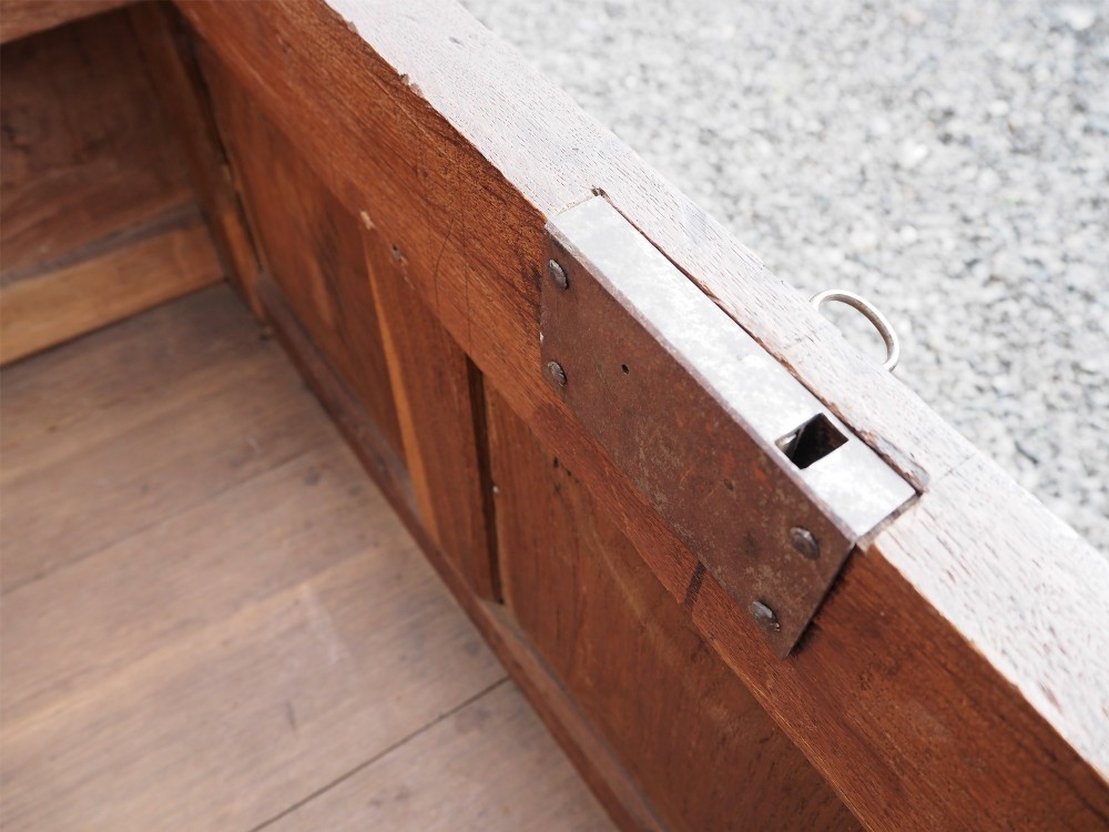 An early 18th-century oak coffer with a three-panel hinged top, carved rosette panels on the front, and a brass keyhole escutcheon. View IX