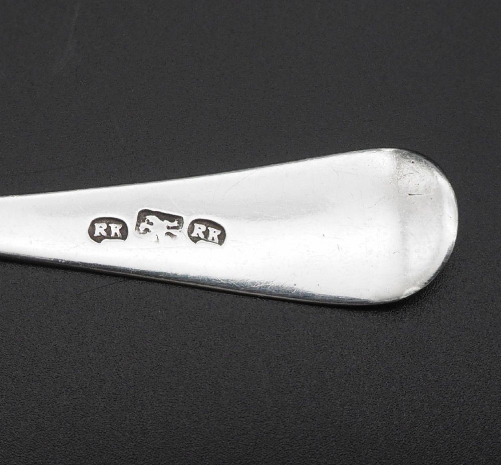 A set of four antique Scottish silver teaspoons with engraved terminal monograms displayed against a dark background. View V