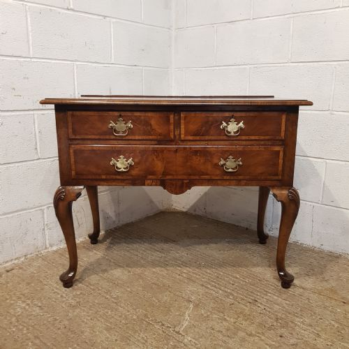 fig 1. AN ANTIQUE BURR WALNUT LOWBOY BY WARING S GILLOWS STAMPED C1920