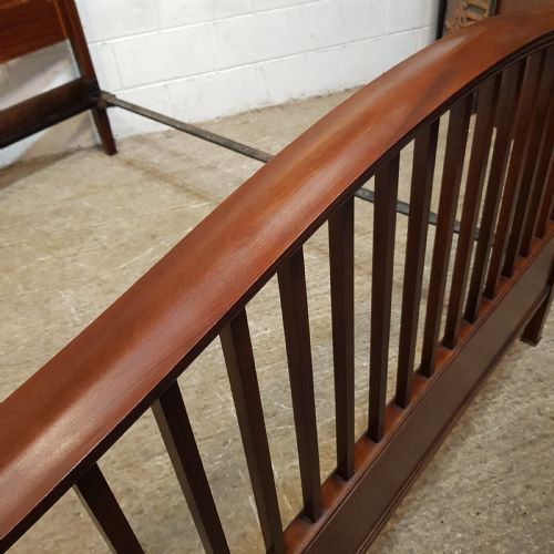 fig 1. An Edwardian mahogany king size bedstead featuring vertical slatted panels on both headboard and footboard, decorated with fine wood inlay.