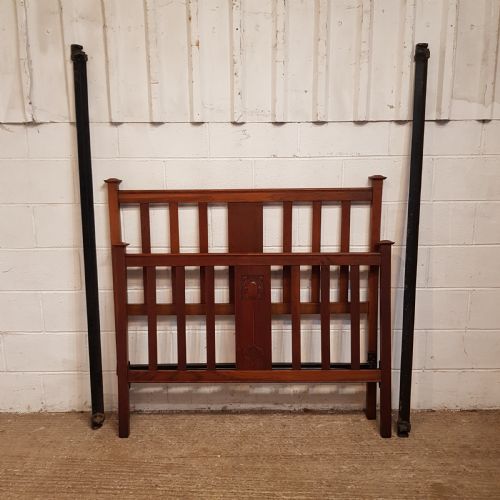 fig 1. An Edwardian oak bedstead featuring slatted timber headboard and footboard panels with a central carved motif.