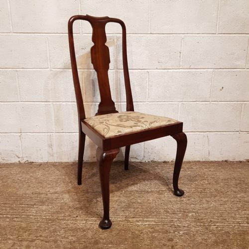 fig 1. A set of eight mahogany Queen Anne style dining chairs featuring vase-shaped back splats, cabriole front legs, and patterned upholstered seats.