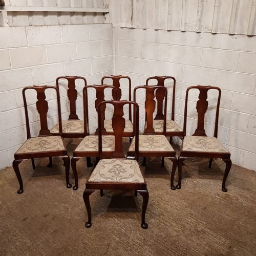 fig 2. A set of eight mahogany Queen Anne style dining chairs featuring vase-shaped back splats, cabriole front legs, and patterned upholstered seats.