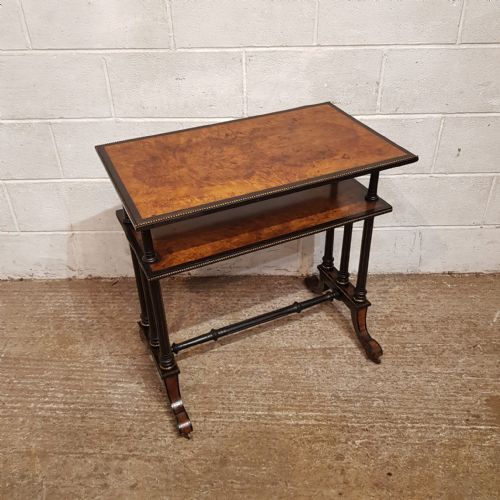 fig 2. A late Victorian two-tier etagere table with burr walnut tops, ebonised turned legs, beaded brass edging, and an H-stretcher base.