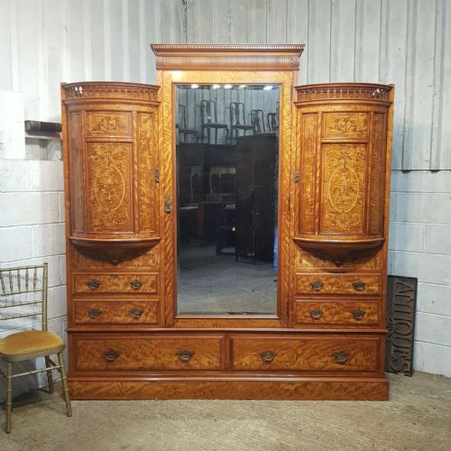 A Satinwood Heavily Inlaid Triple Wardrobe by Shapland and Petter of Barnstable C1890
