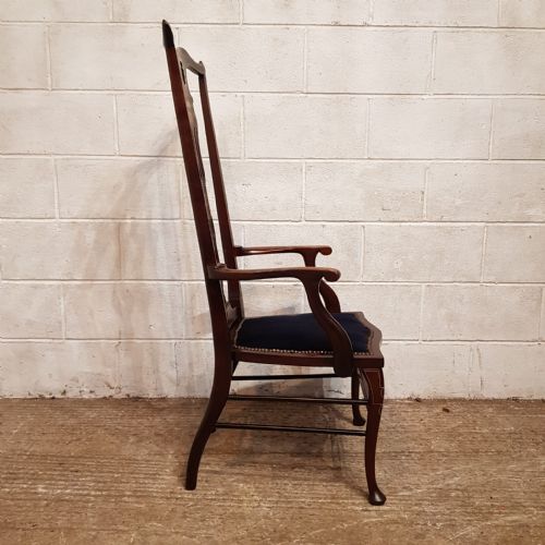 fig 1. A late 19th-century mahogany high-backed armchair featuring intricate floral marquetry inlay and a dark upholstered seat.