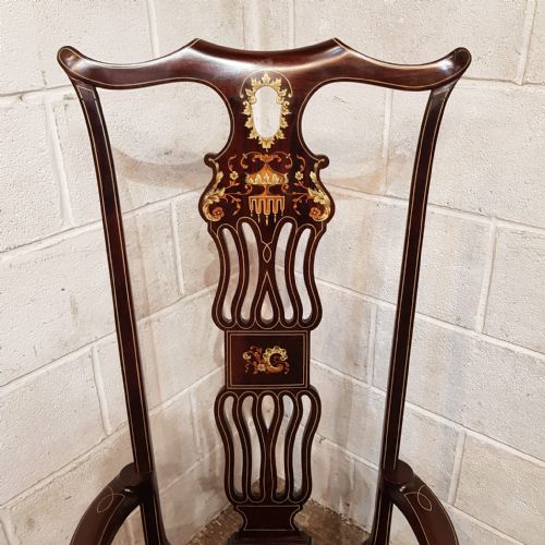fig 2. A late 19th-century mahogany high-backed armchair featuring intricate floral marquetry inlay and a dark upholstered seat.