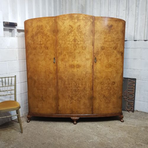 A BURR WALNUT ART DECO BOW FRONTED TRIPLE WARDROBE C1920