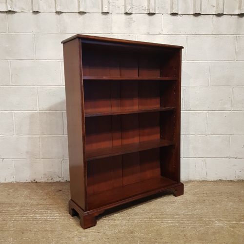 fig 1. An Edwardian mahogany open bookcase featuring four tier shelf spaces, reeded vertical side moulding, and bracket feet.