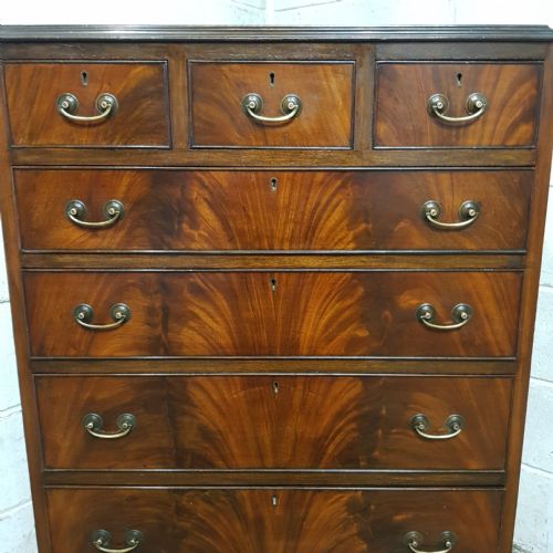 fig 2. A tall mahogany chest of drawers featuring flame mahogany veneer fronts, brass drop handles, and cabriole legs.