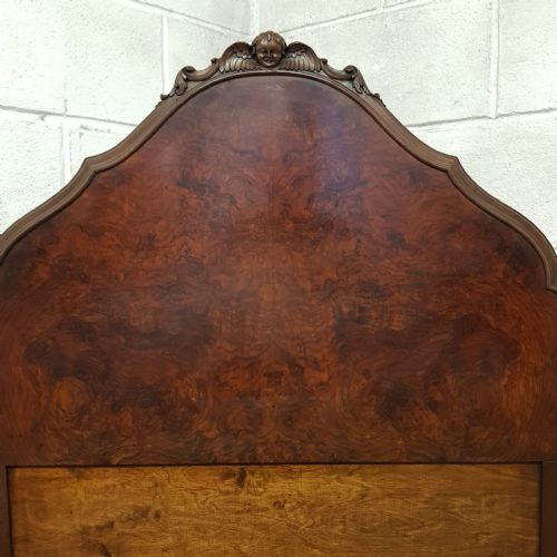 fig 1. A pair of 1920s burr walnut single beds featuring shaped arched headboards, panelled footboards, and carved feet.