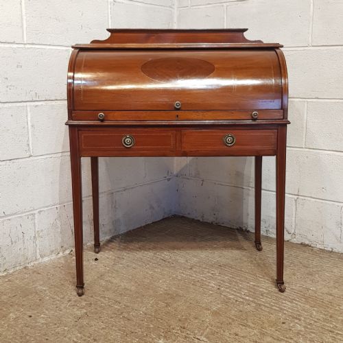AN EDWARDIAN BARREL FRONTED DESK C1900