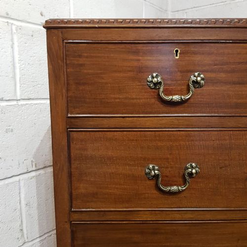 fig 1. An Edwardian mahogany tallboy chest featuring two short drawers over two long drawers and a double-door cupboard base on bracket feet.