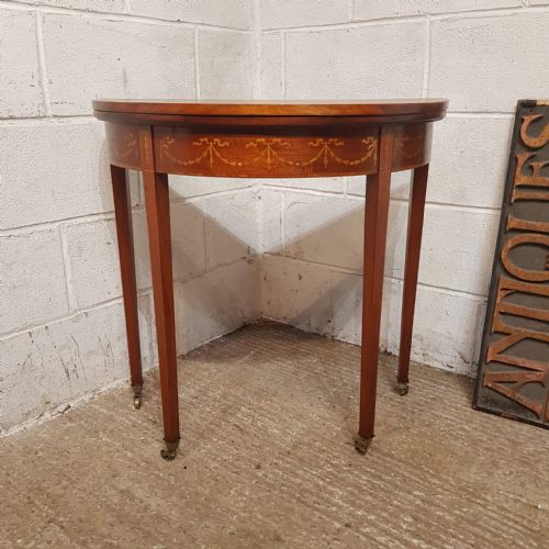 A REGENCY MAHOGANY INLAID DEMI LUNE FOLD OVER GAMES SIDE TABLE C1810