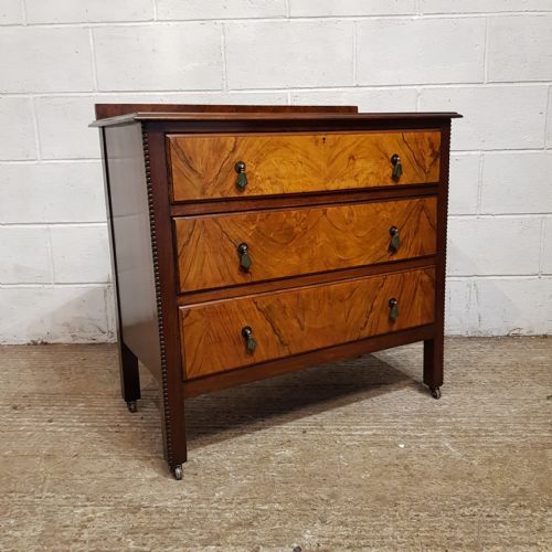 fig 1. A matching pair of three-drawer chests crafted from walnut with prominent burr walnut veneer drawer fronts and low gallery backs.